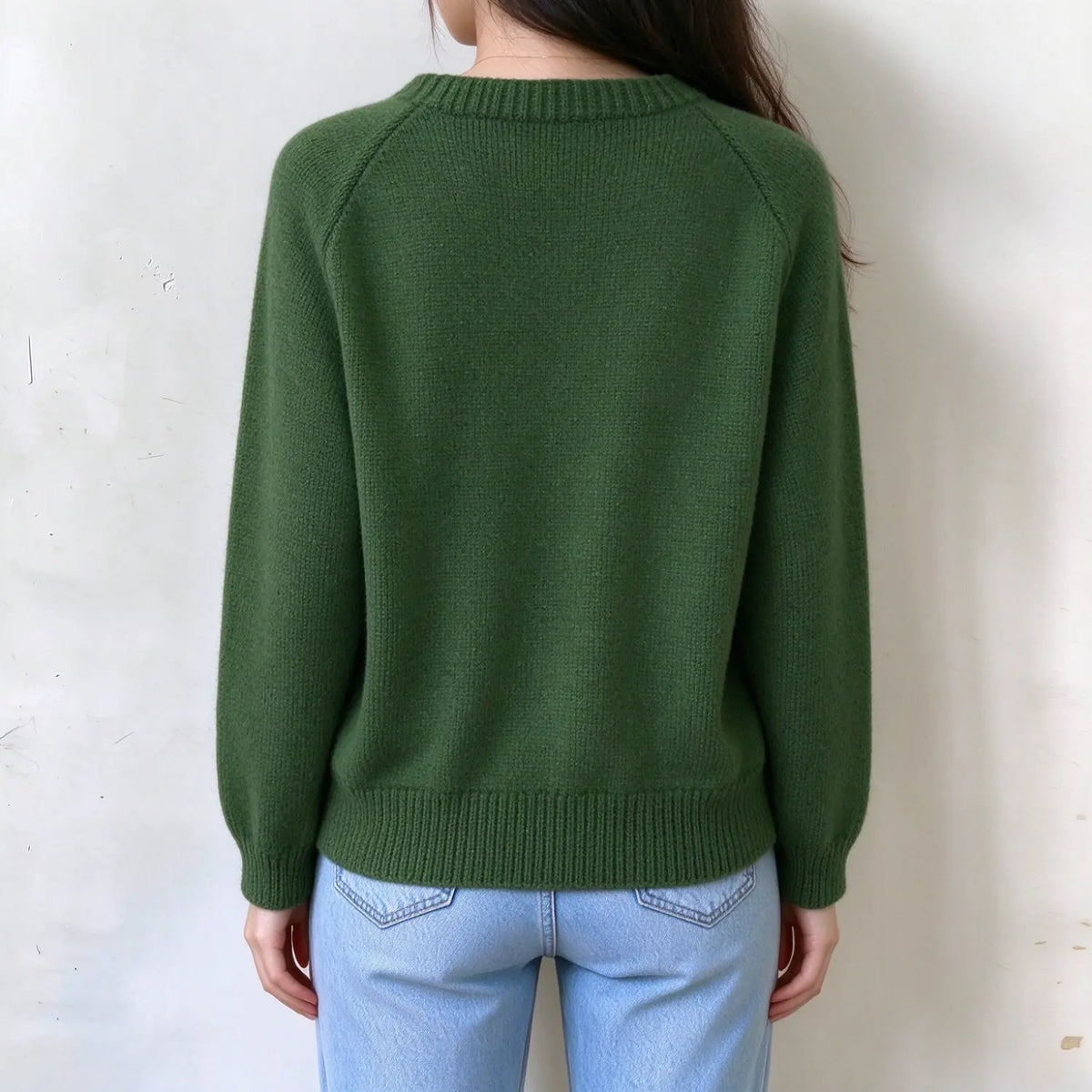 Female model back view, solid forest green raglan knit sweater, plain back, ribbed neckline, hem and sleeve cuffs