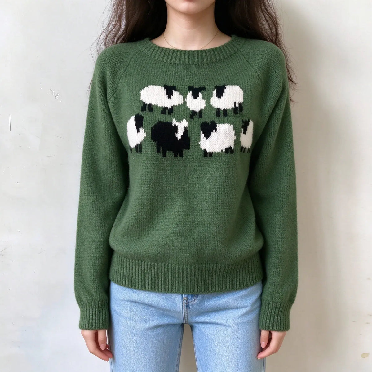 Female model wears forest green knit sweater, cartoon sheep jacquard motif on front chest, raglan long sleeve casual pullover