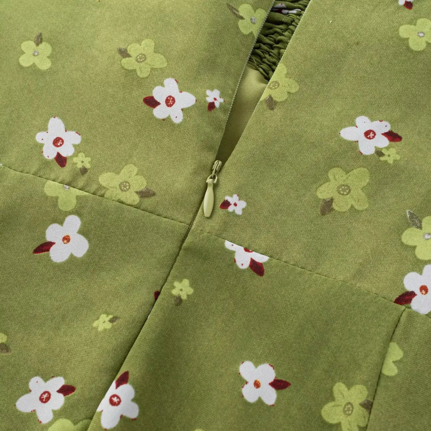Avocado green tiny floral cami dress back invisible zipper macro flat shot, smooth hidden zipper spliced chiffon floral fabric white background detail