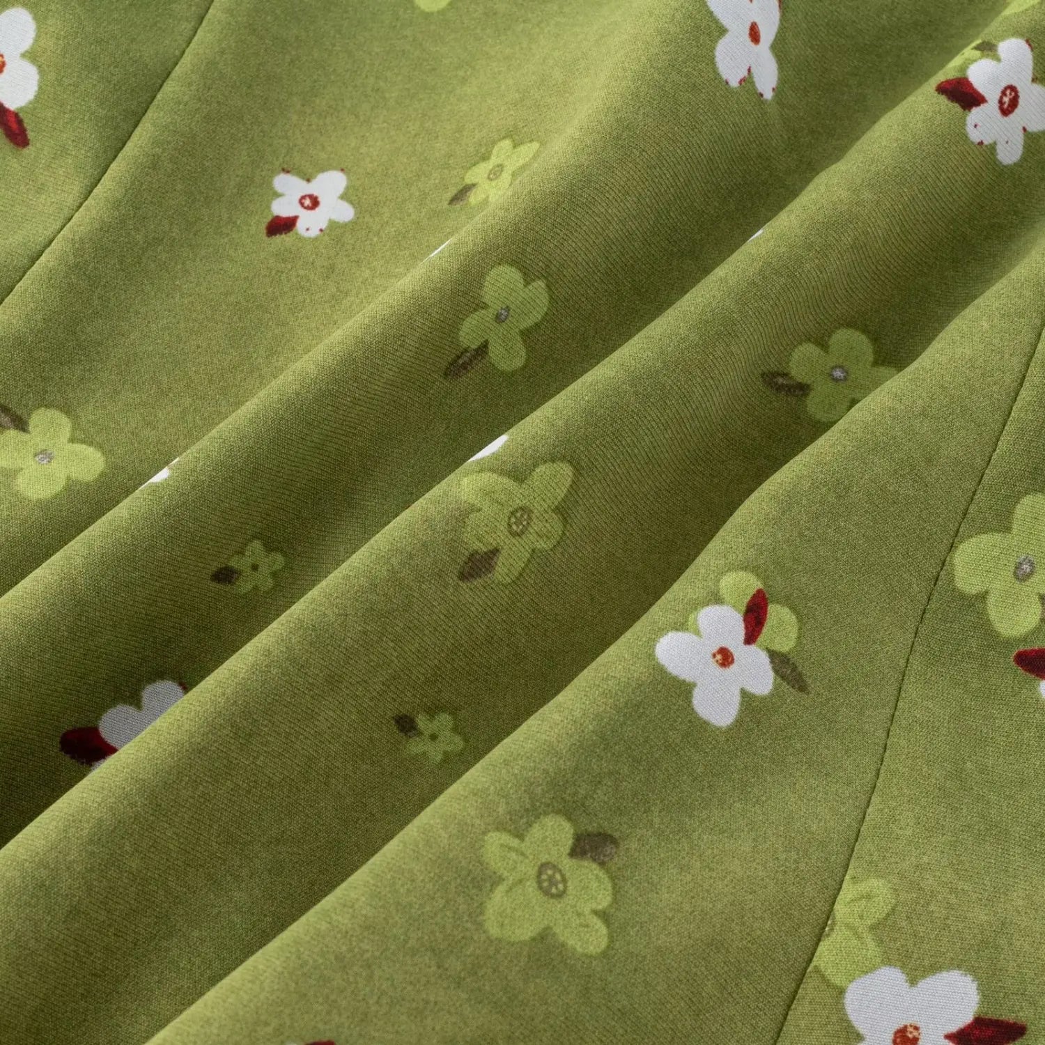 Avocado green tiny floral chiffon fabric macro flat shot, soft drape textile evenly printed small flower natural wrinkle texture white background detail