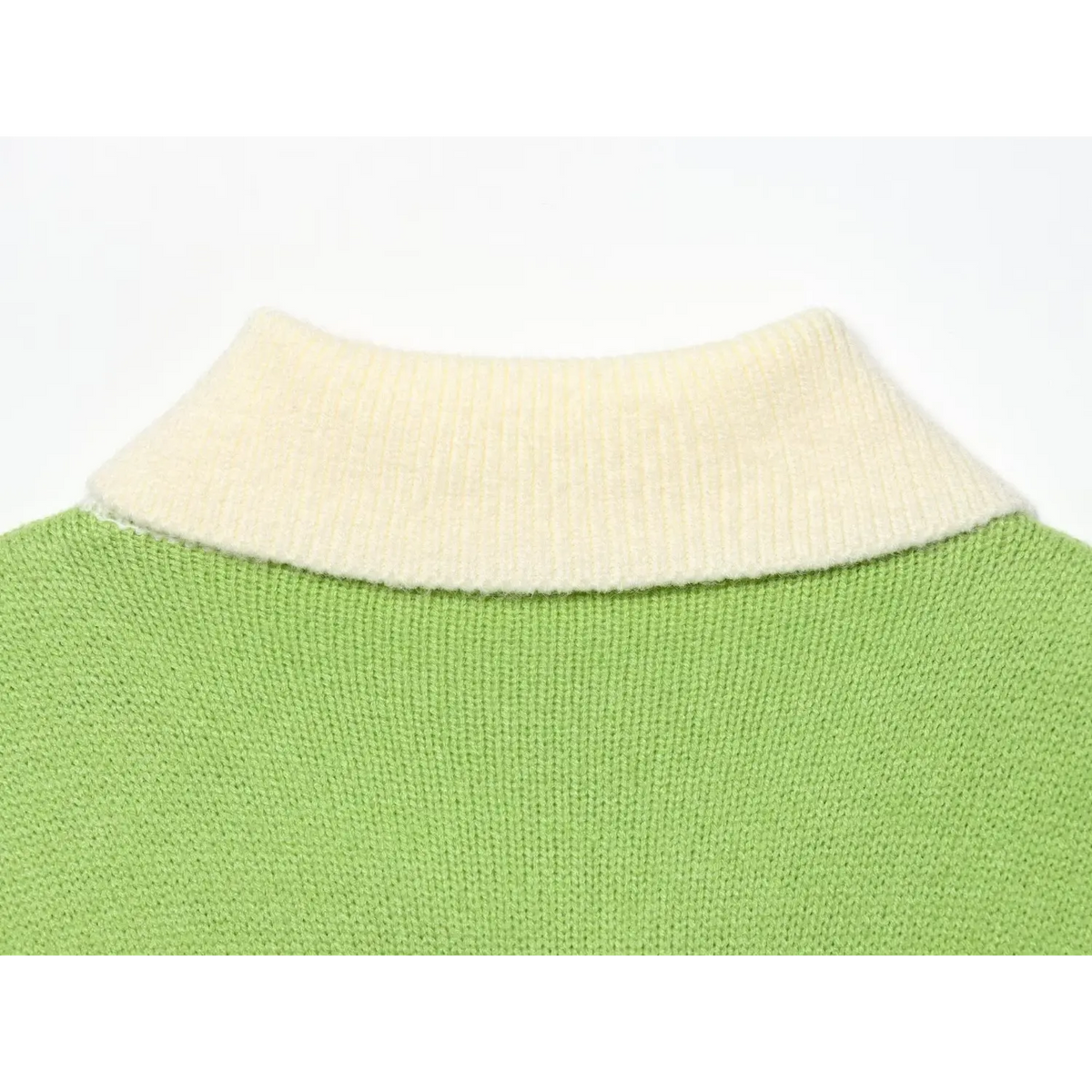 Close-up of cream ribbed collar joined to green knit body