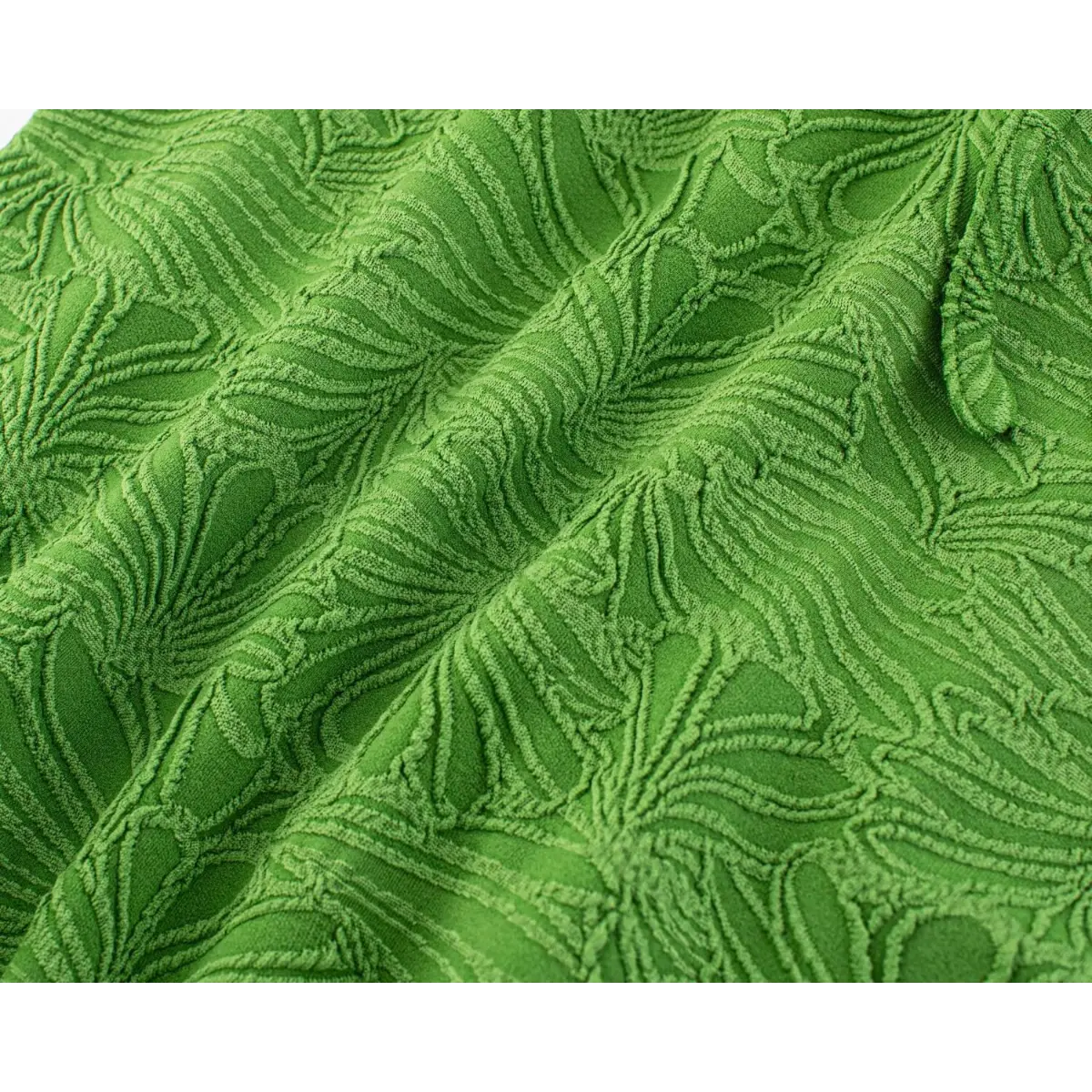 Close-up shot of the green embossed leaf fabric, showing the raised texture and detailed leaf pattern.