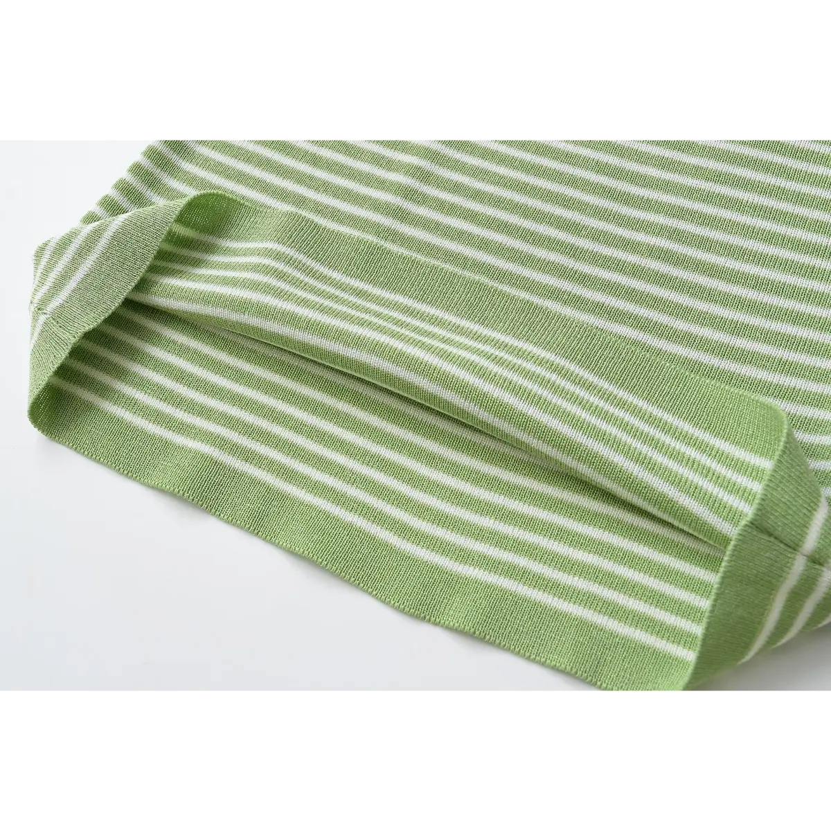 Close of ribbed hem on green white striped knit tube top