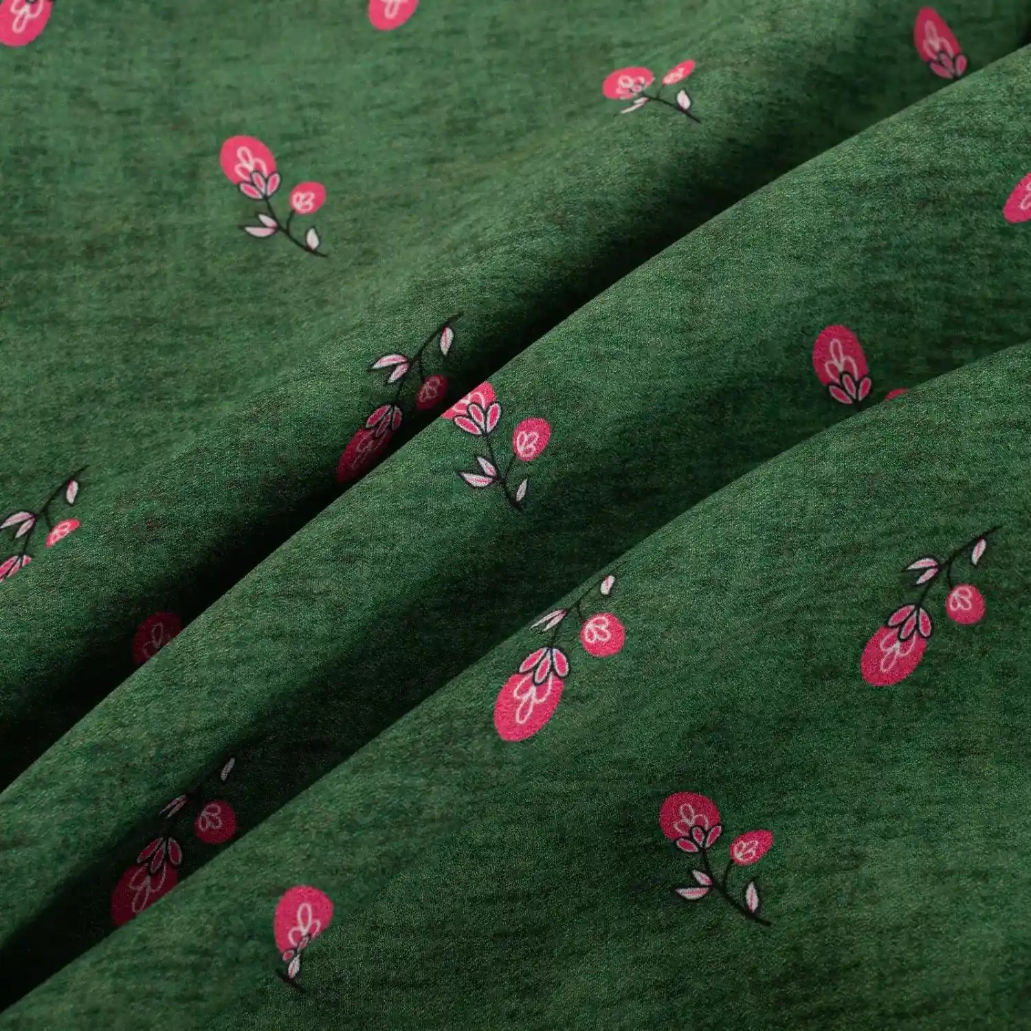 Macro close‑up of green fabric with pink fruit print pattern
