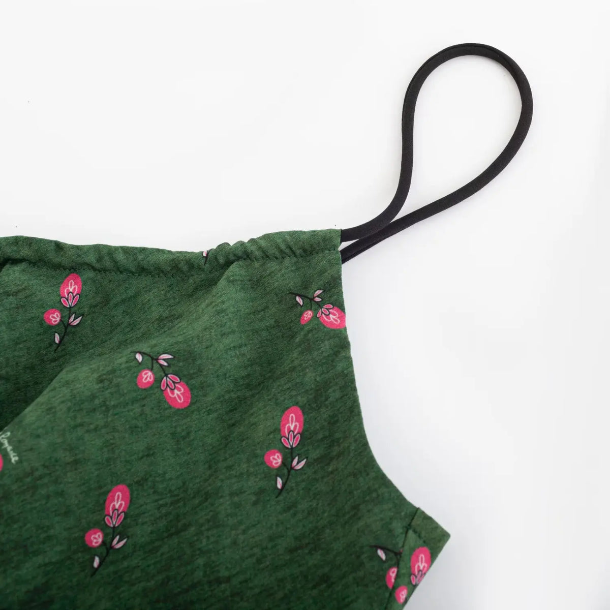 Close‑up of thin black spaghetti strap and armhole detail
