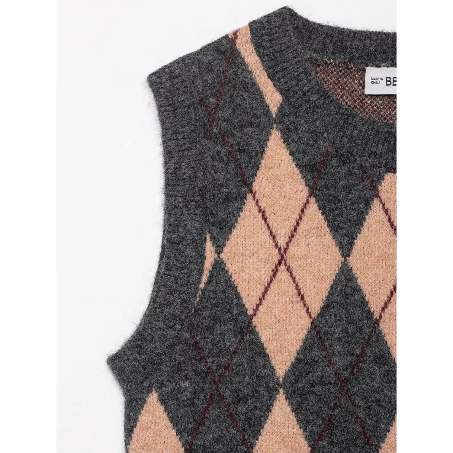 Partial view of the armhole and crew neckline showing knit texture