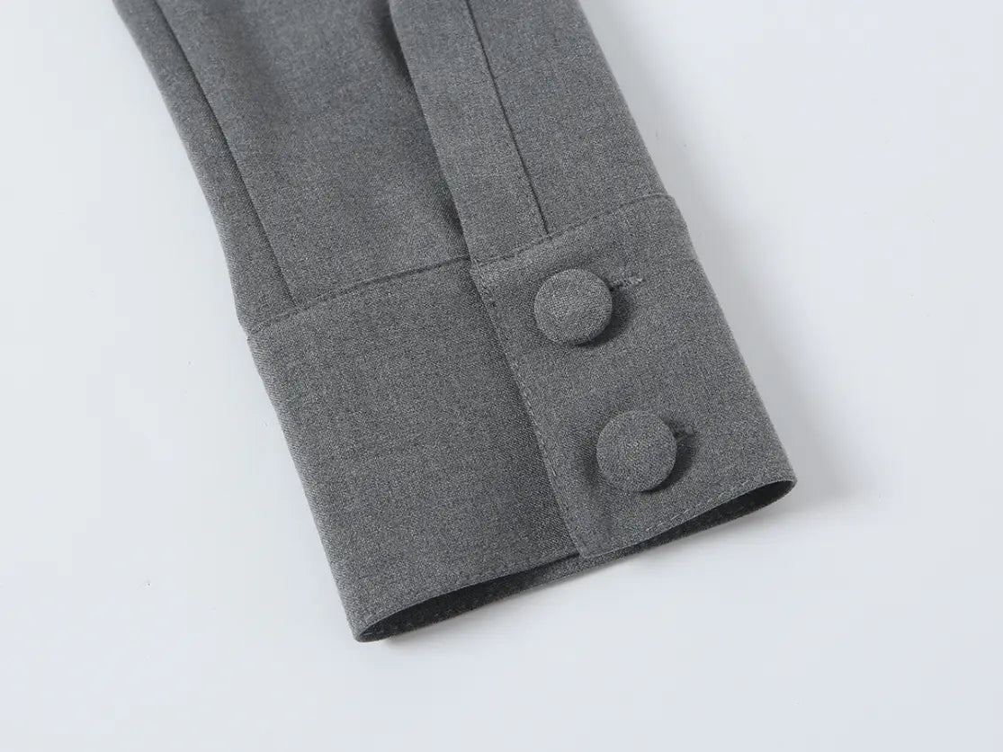 Close-up of cuff with two fabric-covered buttons