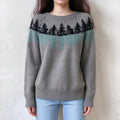 Female model wears grey fairisle sweater, pine tree jacquard pattern on yoke, ribbed crew neck, relaxed fit long sleeve knit top, front torso shot