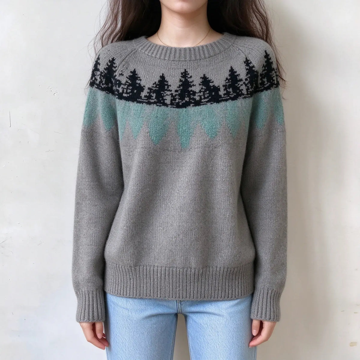 Female model wears grey fairisle sweater, pine tree jacquard pattern on yoke, ribbed crew neck, relaxed fit long sleeve knit top, front torso shot