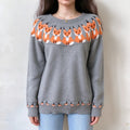 Model front view wearing grey crew neck knit sweater, adorable orange fox jacquard motif on upper chest and bottom hem, relaxed fit long sleeve pullover, simple white background