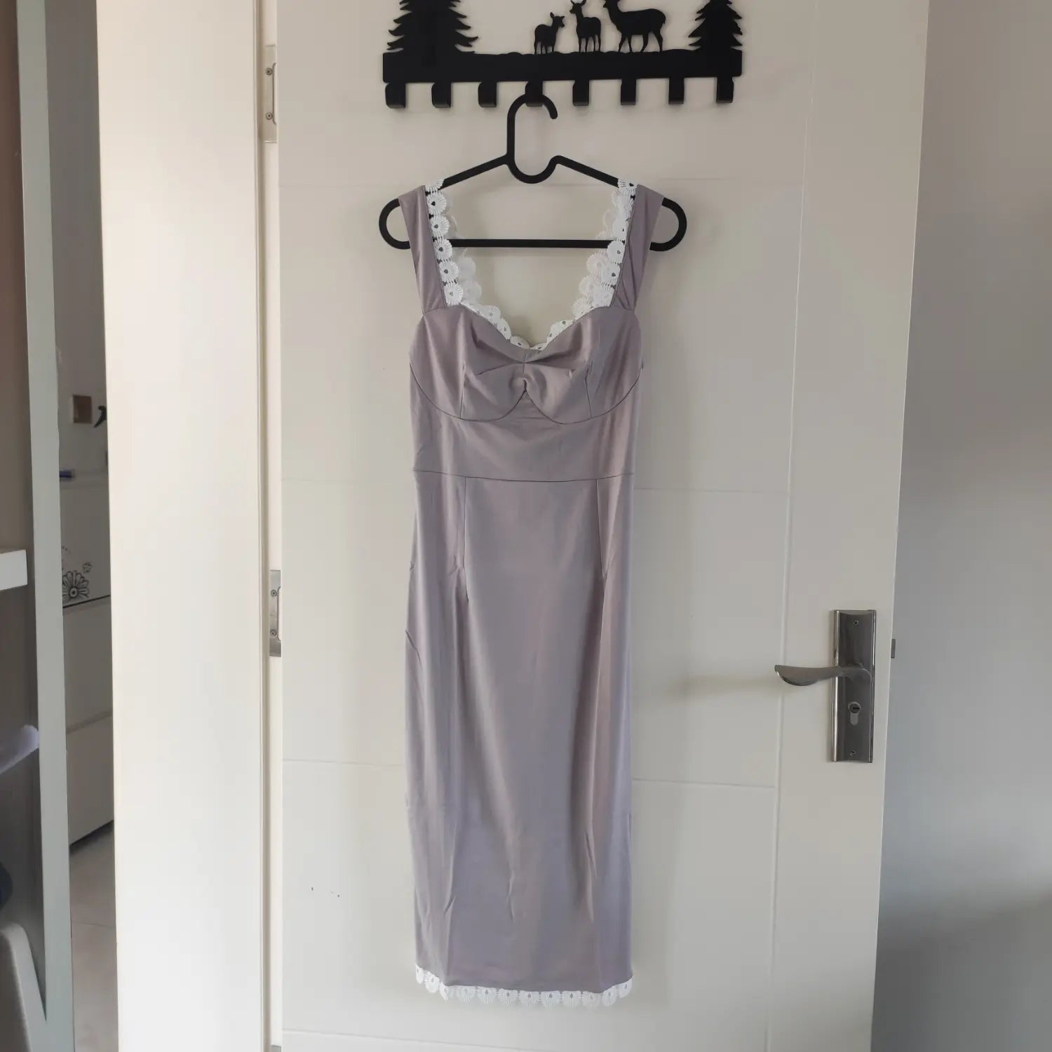 Hanging front view grey sleeveless bodycon midi dress decorated with white floral lace trim