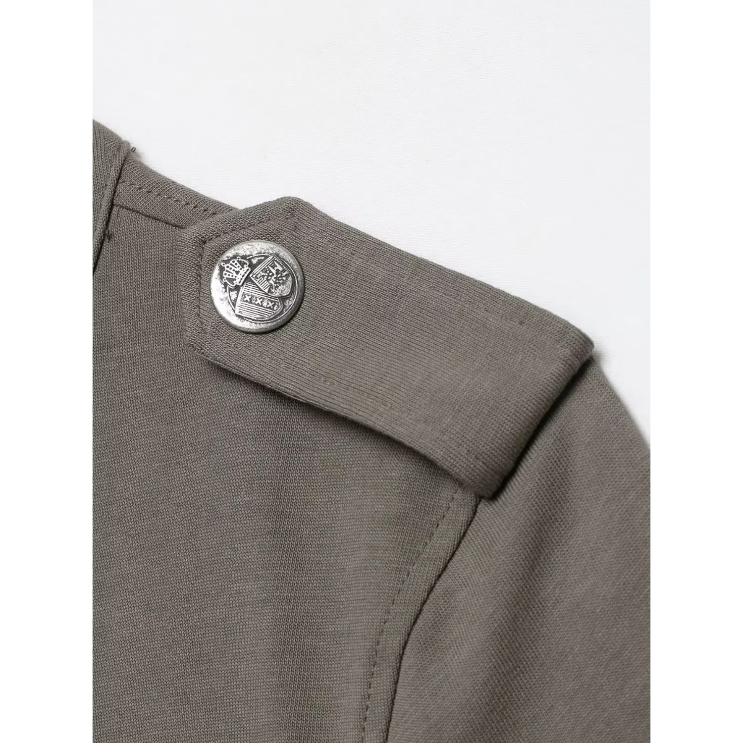 Macro close‑up epaulet embossed crest metal button on grey military knit top