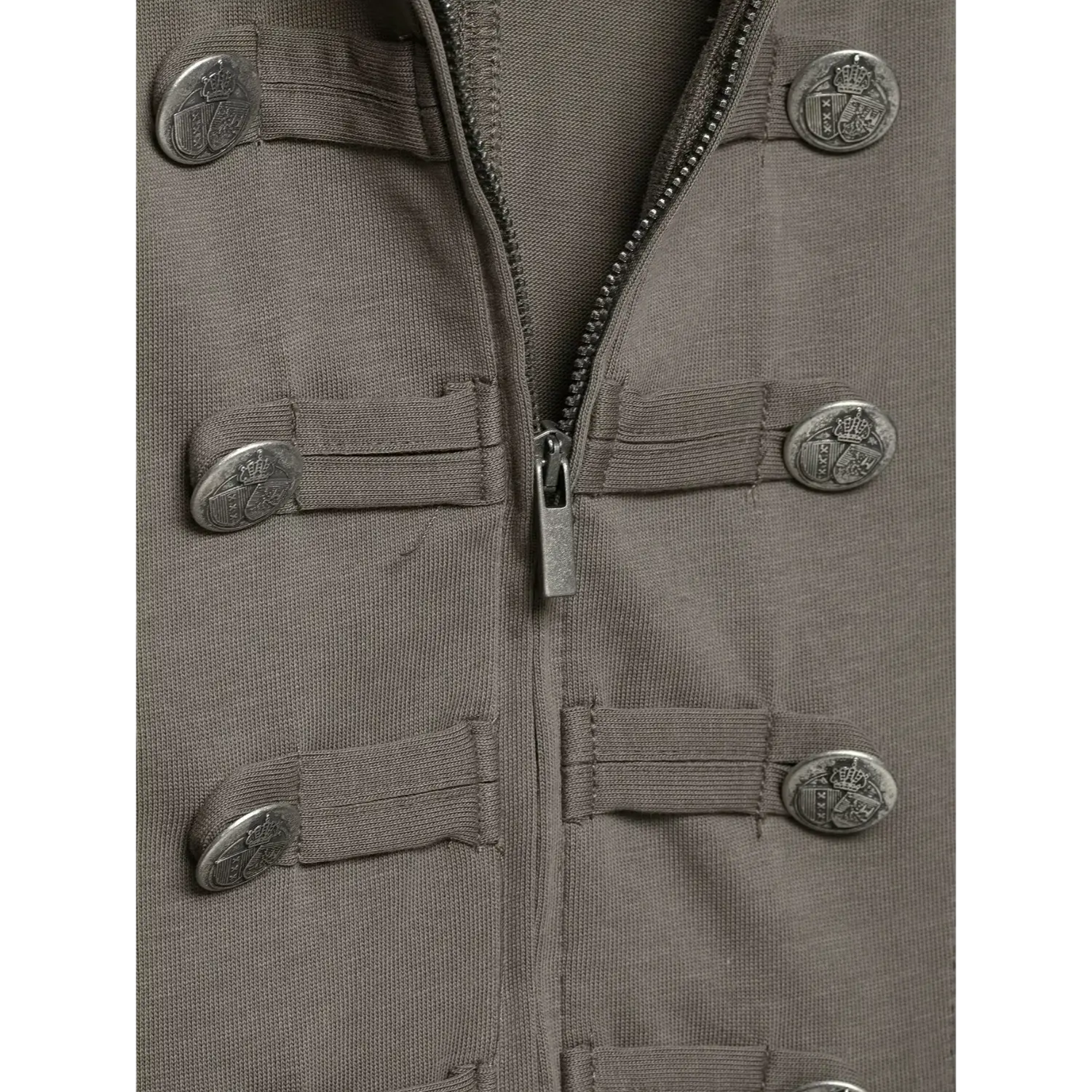Close‑up detail shot grey military style short sleeve top, double row embossed metal buttons and center front zipper