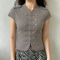 Model wearing grey fitted military‑inspired short sleeve top, full front view paired with zebra print bottom