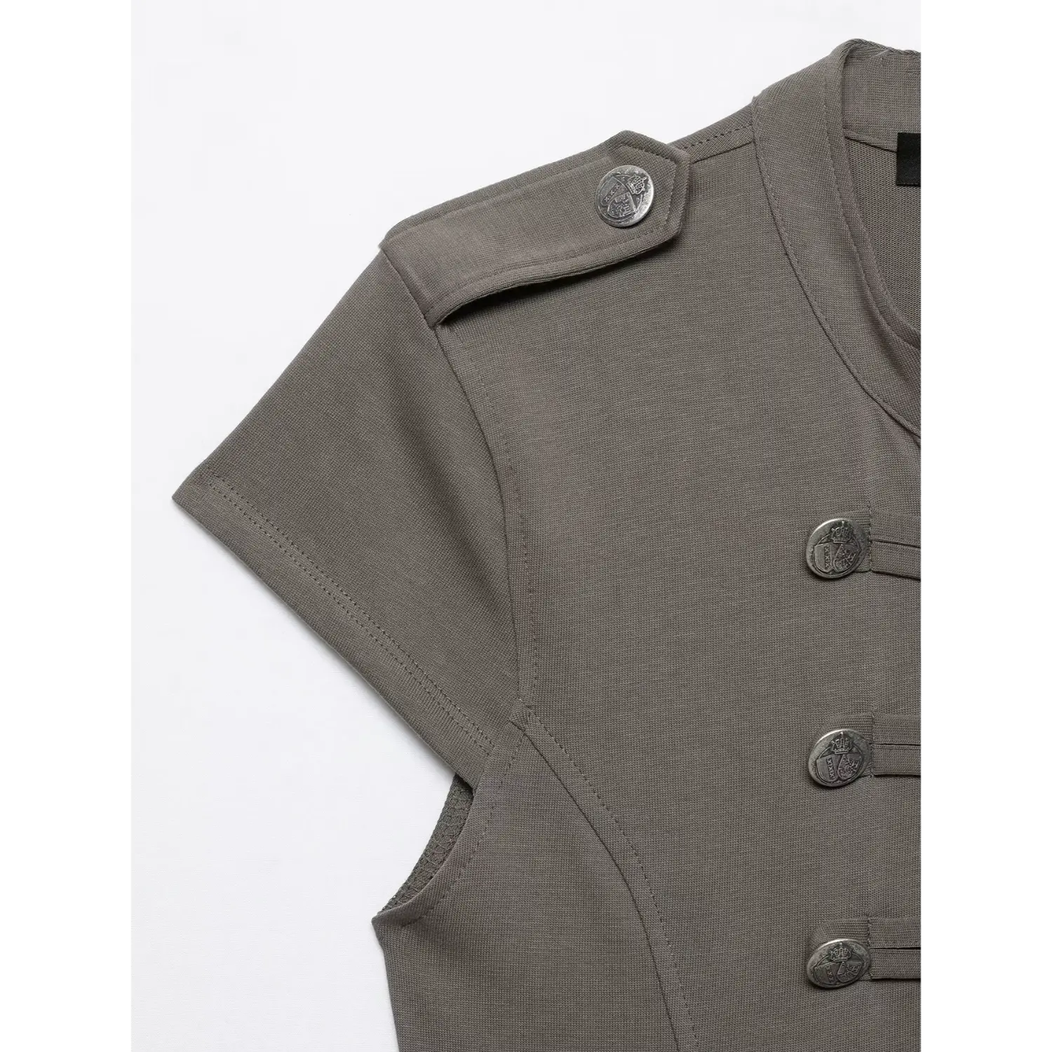 Close‑up shoulder detail grey military top, epaulet with embossed crest metal button, cap sleeve and seam construction