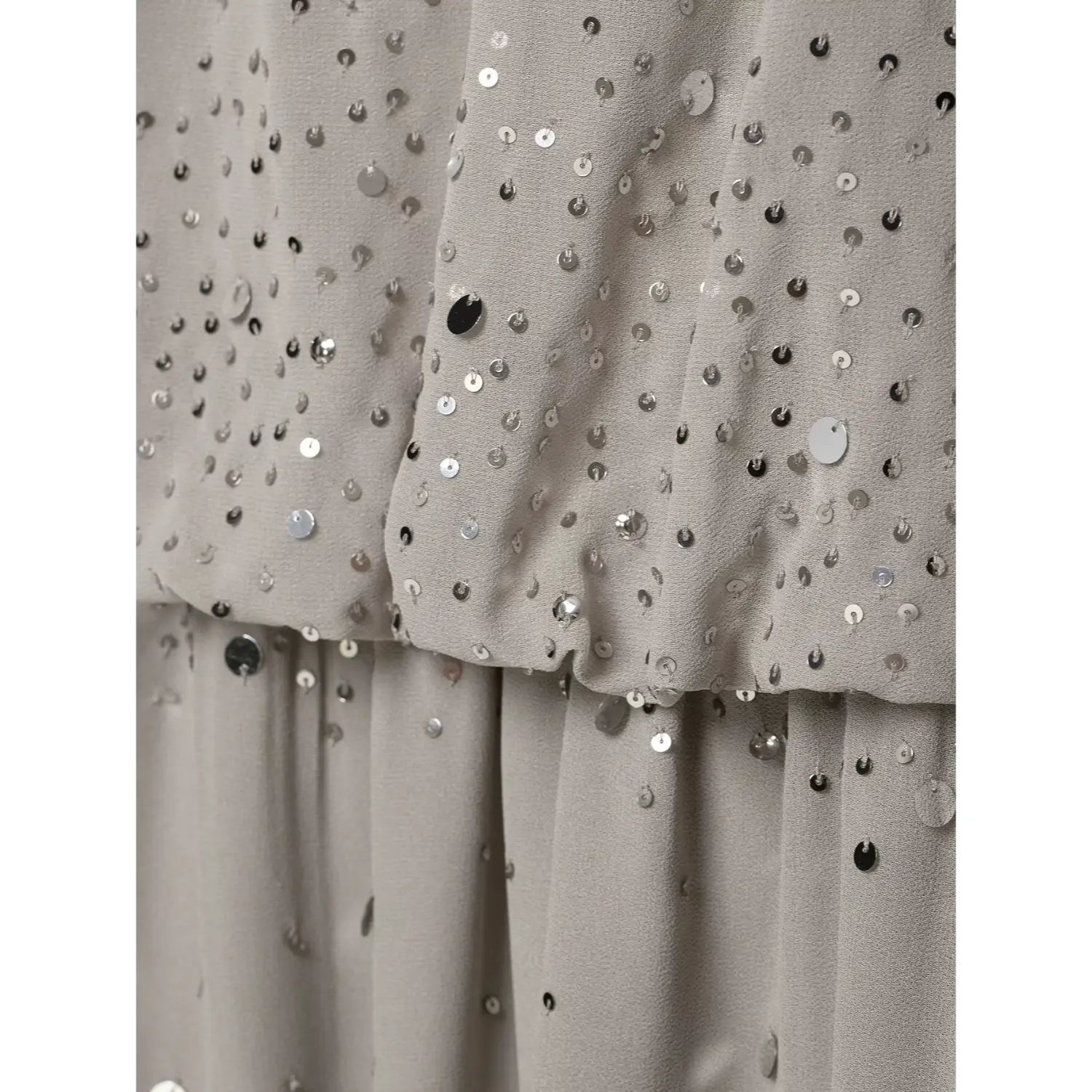 Close‑up of elastic waist tier seam, gradient scattered silver sequins across two‑layer grey chiffon skirt