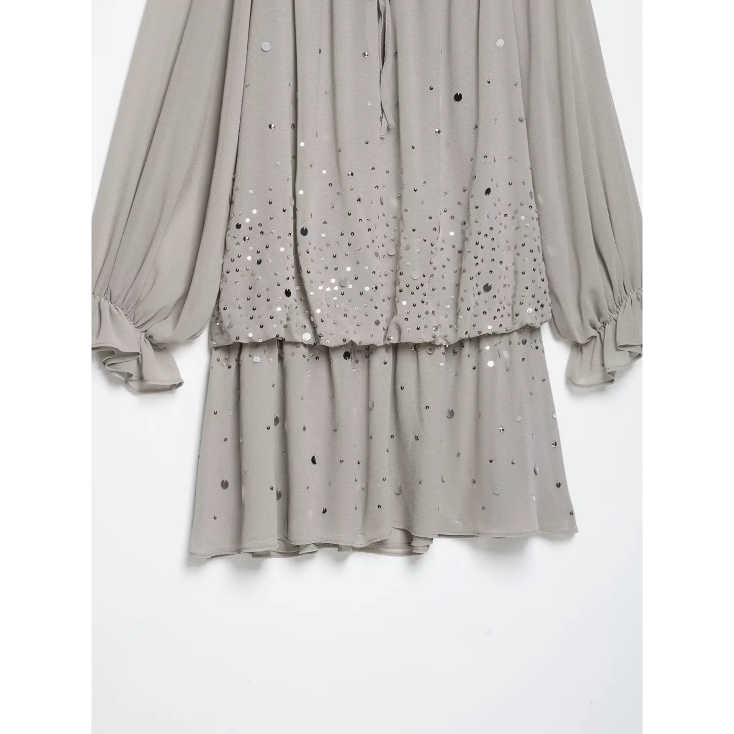 Lower view of tiered mini skirt hem, ombre scattered silver sequins, loose flowy grey chiffon silhouette