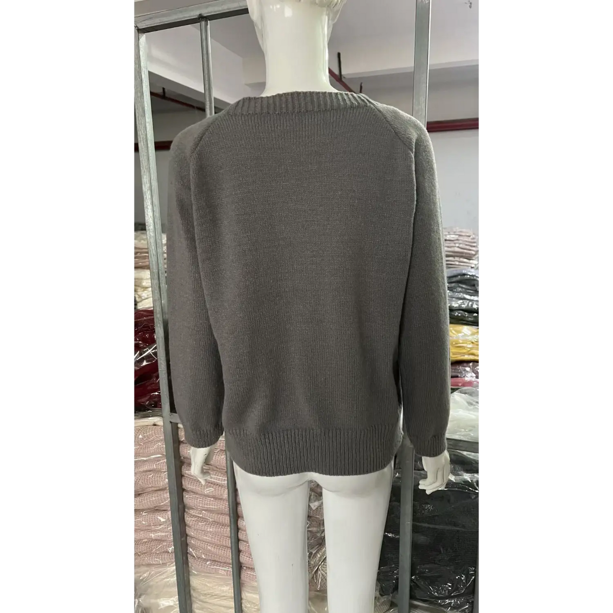 Back view of grey sheep intarsia crew neck knit sweater on mannequin