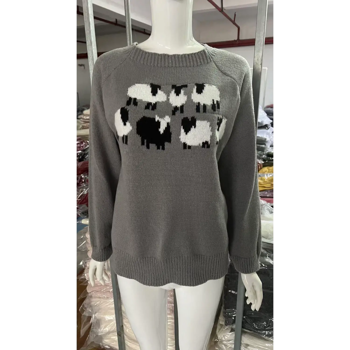 Front view of grey sheep intarsia crew neck knit sweater on mannequin