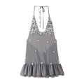 Front view of the grey shell button halter dress, featuring the scattered shell button embellishments, deep V-neckline, and flowy ruffled hem