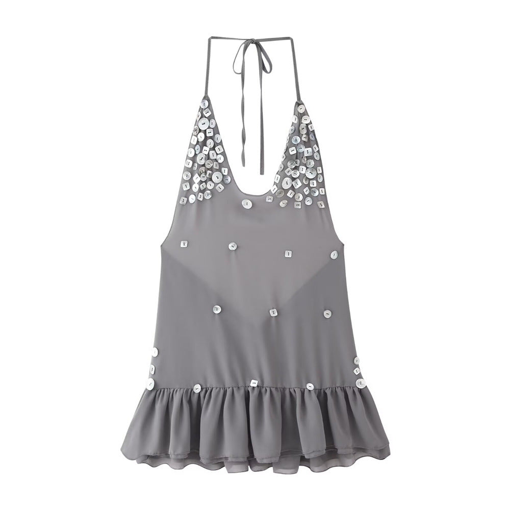 Front view of the grey shell button halter dress, featuring the scattered shell button embellishments, deep V-neckline, and flowy ruffled hem