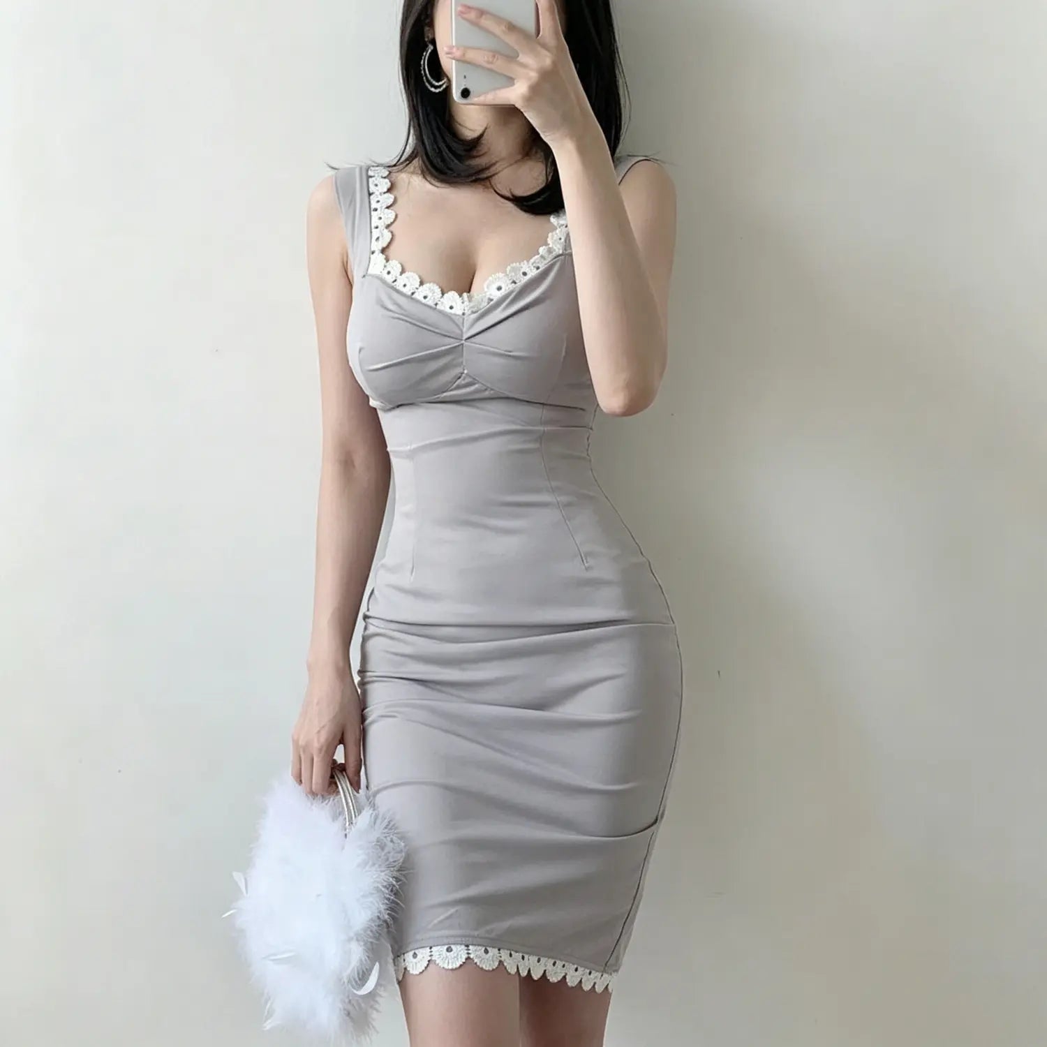 Model mirror selfie front view grey sleeveless bodycon midi dress with white floral lace trim