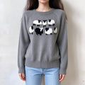 Female model wears grey knit pullover, cute black and white sheep jacquard pattern on chest, raglan sleeve crew neck sweater