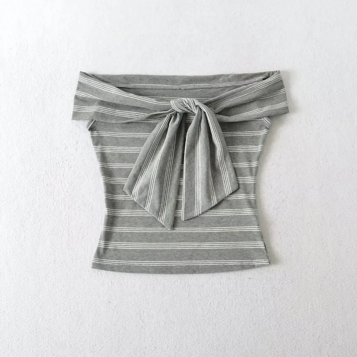 Front view of the grey and white striped off-shoulder top, highlighting the tie detail and fitted cut.