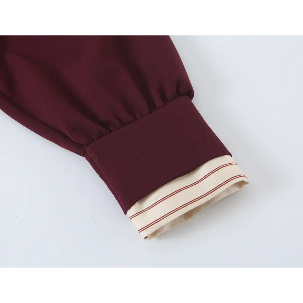 Close-up of bishop sleeve cuff and striped trim