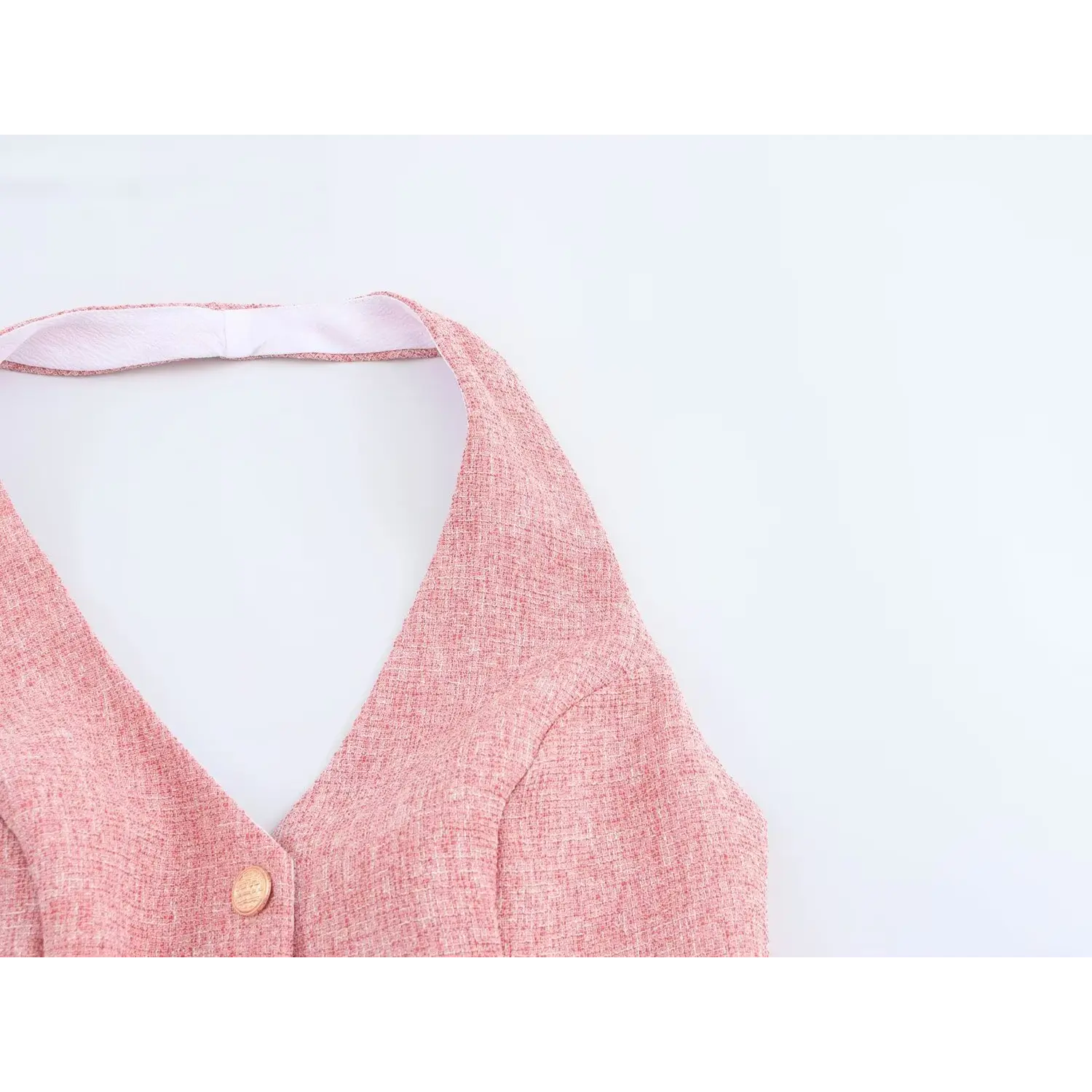 Upper front neck shot, folded tweed binding edge, full smooth white inner lining, sleeveless cut exposing shoulder line