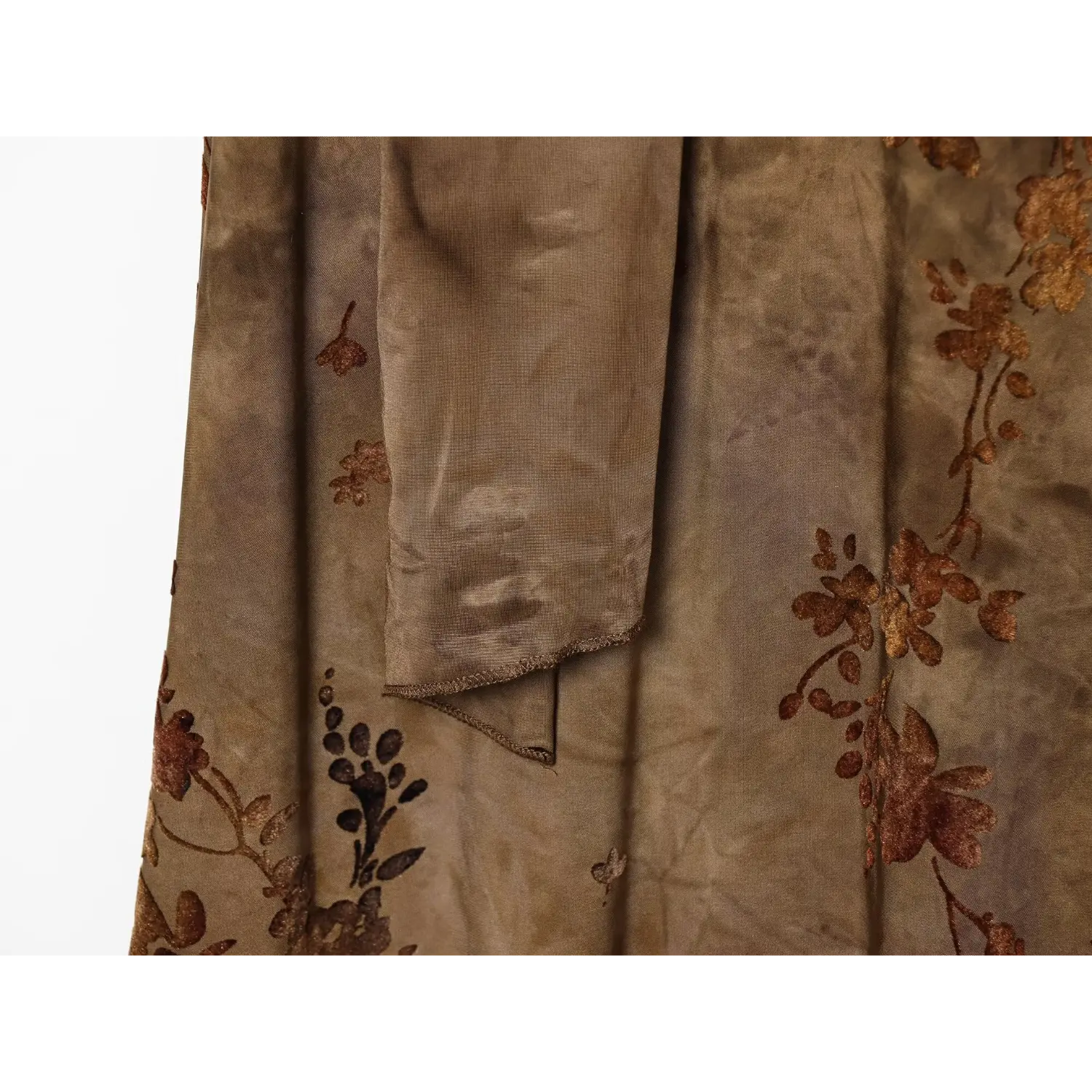 Close‑up of back button closure and halter strap detail on brown floral maxi dress