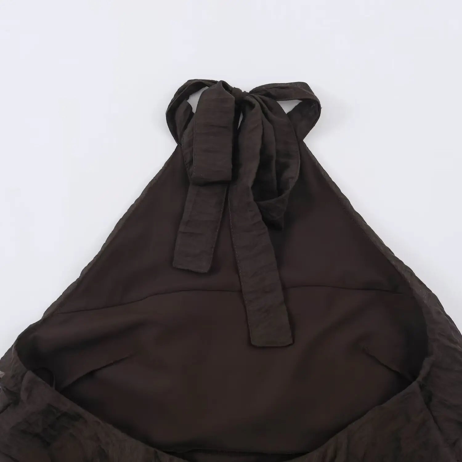 Inside back view of dark brown halter mini dress, halter strap base and back tie attachment, full inner lining