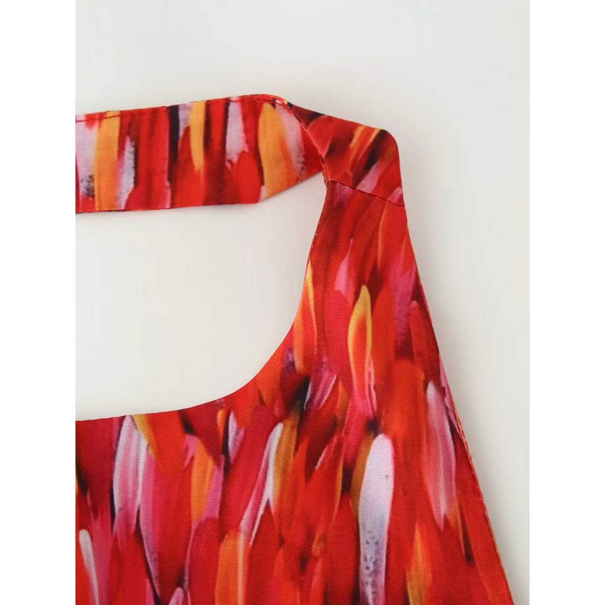 Close‑up halter strap edge stitching red abstract print tiered maxi dress