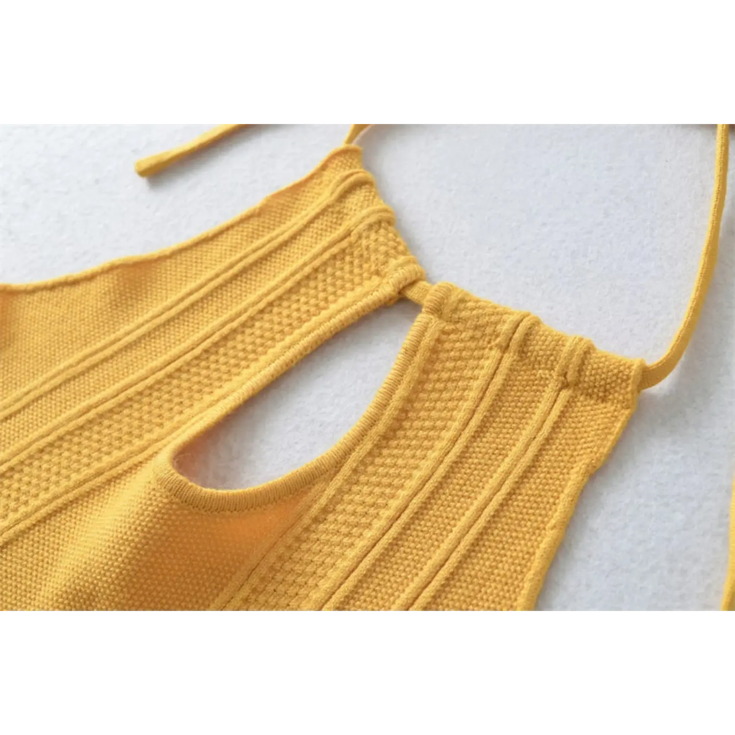 Mustard yellow halter knit dress bust cutout flat close-up, neck tie gathered keyhole vertical rib knit edge stitching white background shot