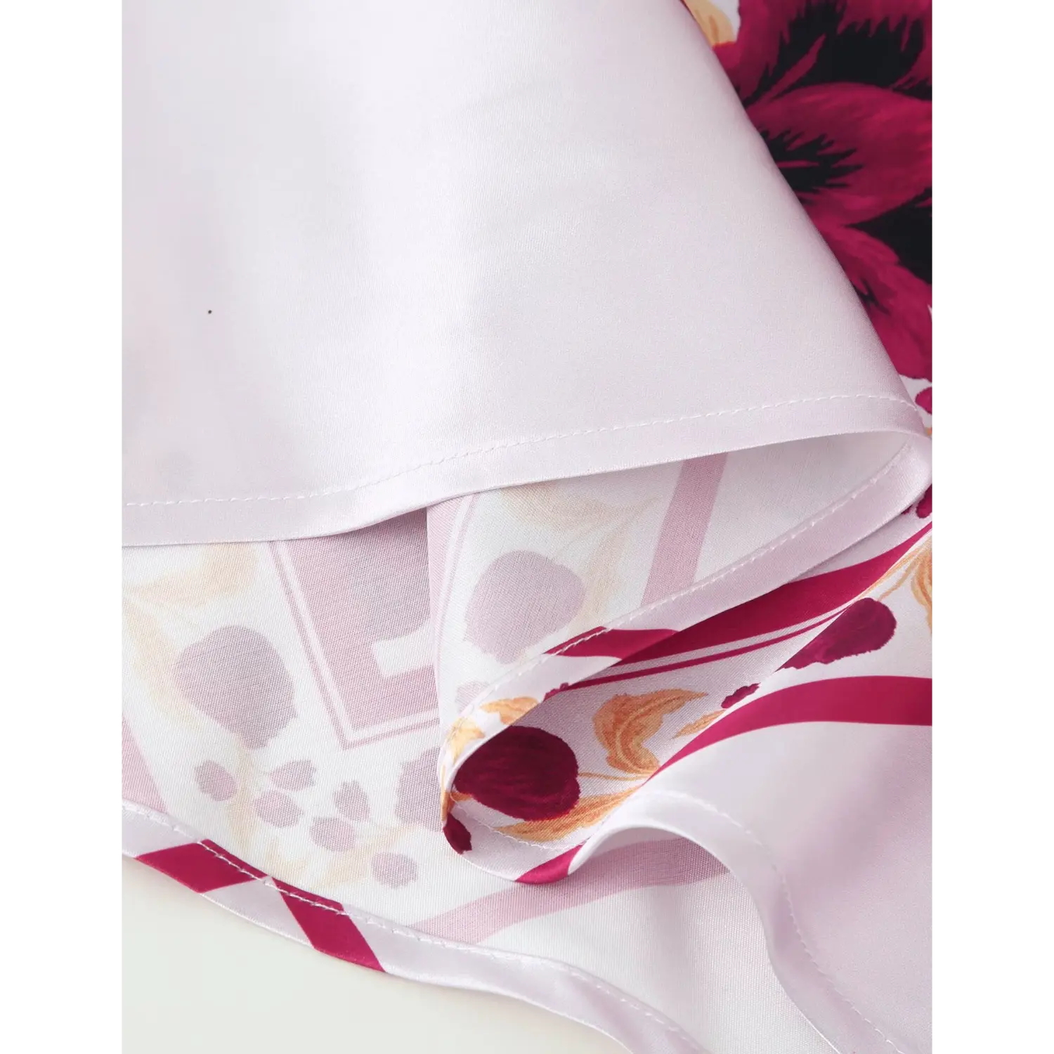 Close‑up of maxi dress hem inner lining, layered satin fabric and stitching workmanship