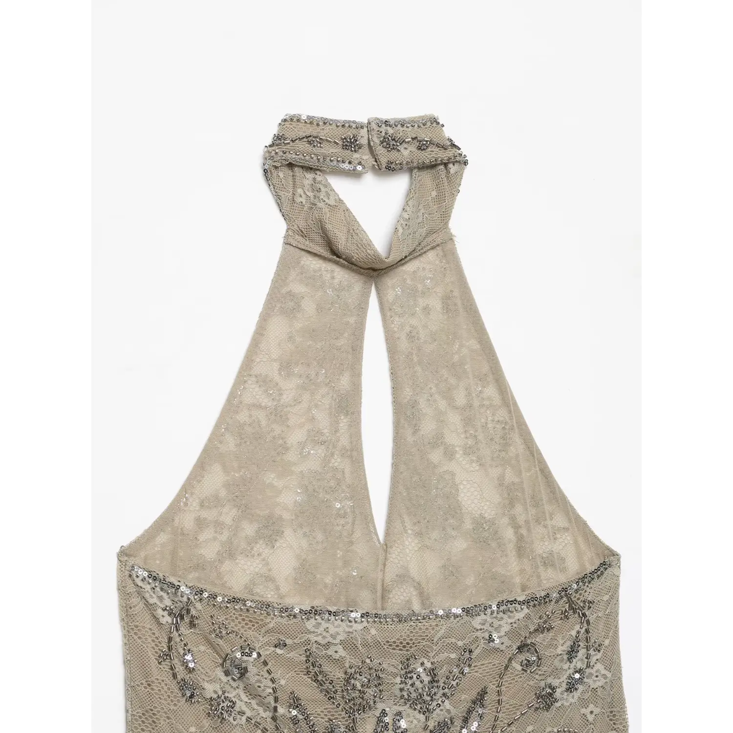 Close‑up back view halter neck cutout and fabric button closure on sheer beaded beige lace halter top