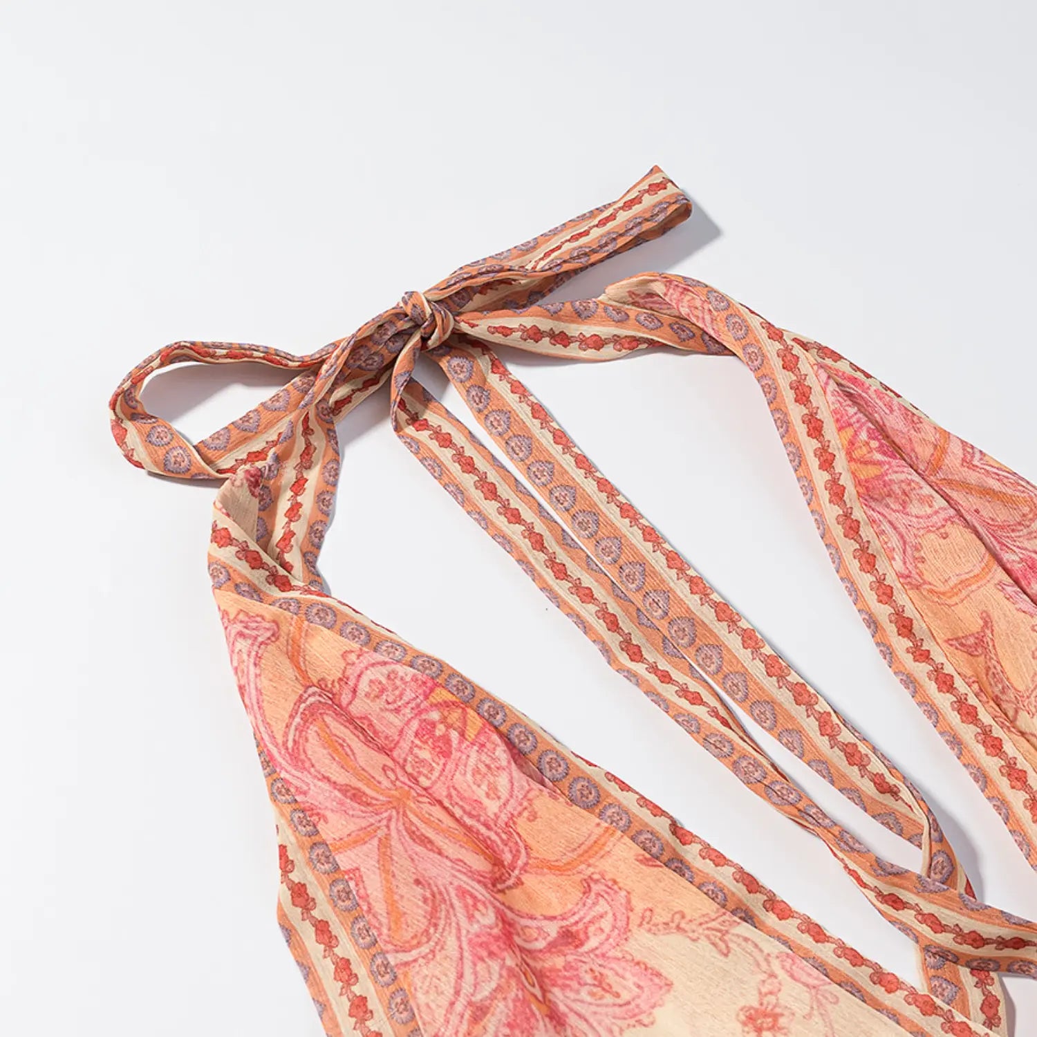 Halter back neck partial shot, long matching print fabric tie straps, decorative border edging