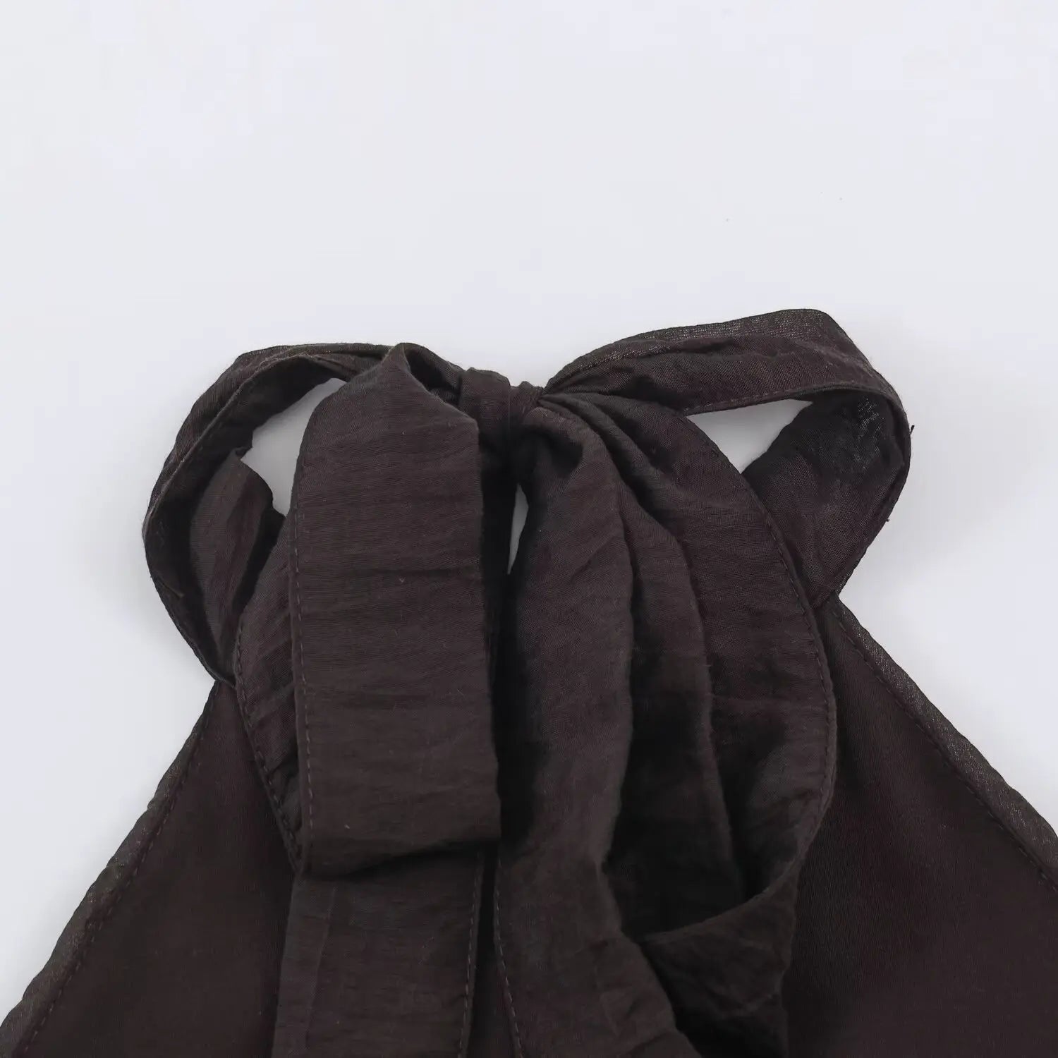 Back neck self-fabric tie bow close-up, adjustable halter ribbon for dark brown tier ruffle dress