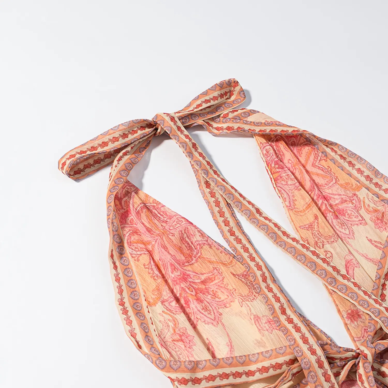 Halter neck strap bow close-up, decorative floral border printed fabric ties