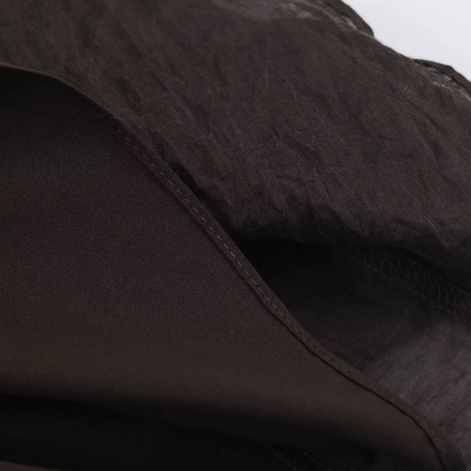 Inner lining close-up, solid brown lightweight lining fabric, clean seam workmanship
