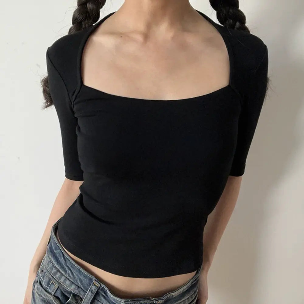 Lifestyle shot of model wearing the black halter square-neck mid-sleeve fitted top