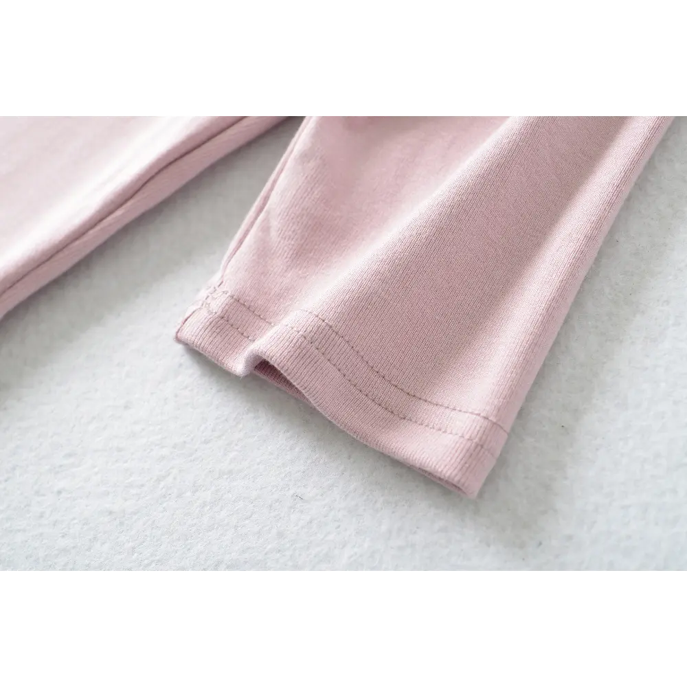 Close-up of the cuff stitching on the pink halter square-neck top
