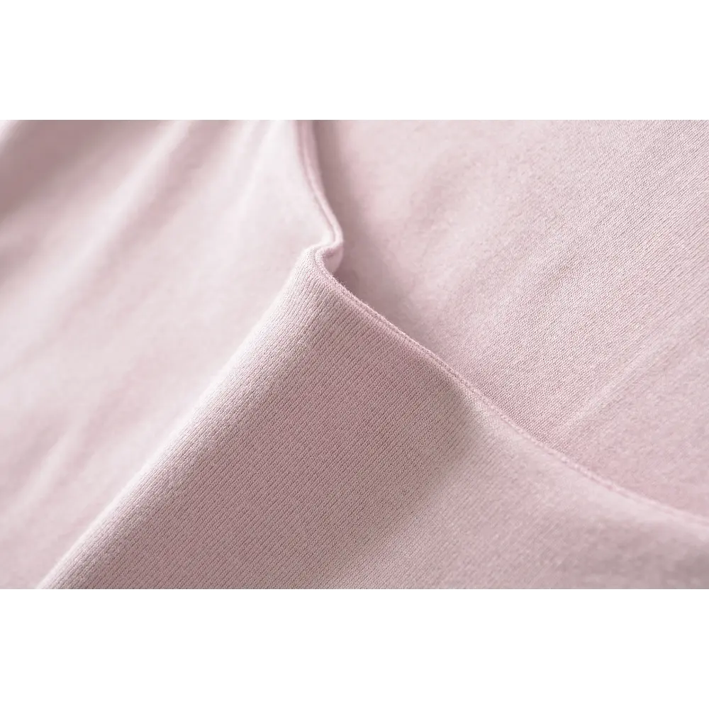 Close-up of the ribbed fabric texture on the pink halter top