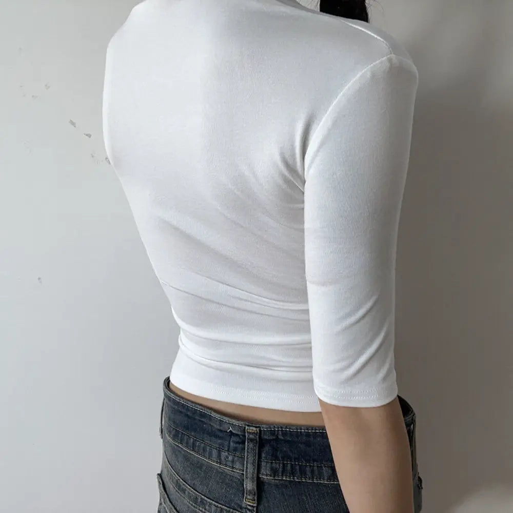 Lifestyle back view of model wearing the white halter square-neck mid-sleeve fitted top