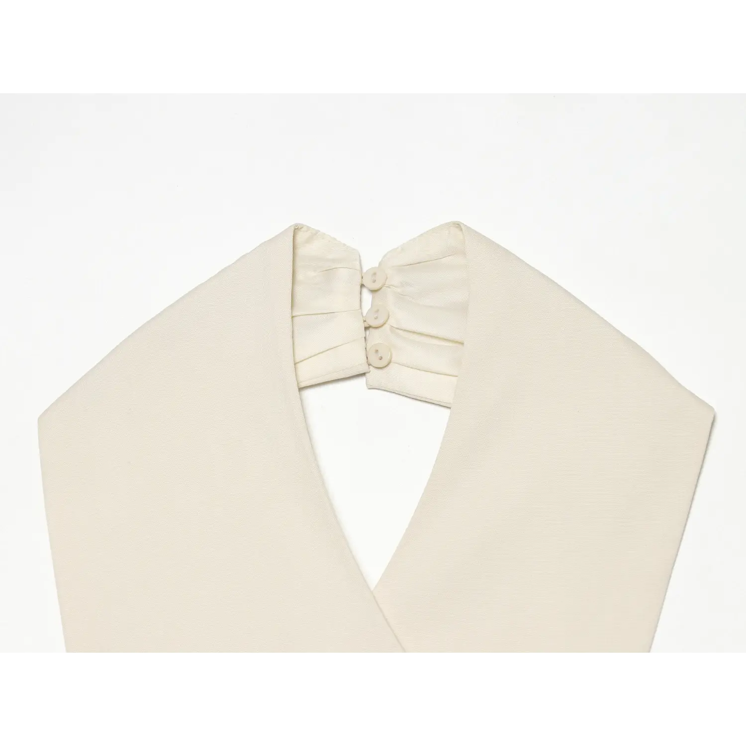 Close-up back neck placket with matching buttons of cream sleeveless halter top