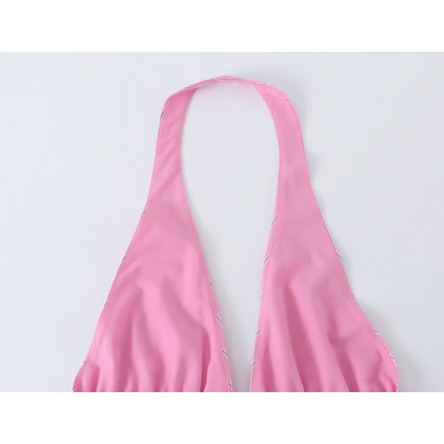 Back partial shot of solid halter neck strap and shoulder seam construction