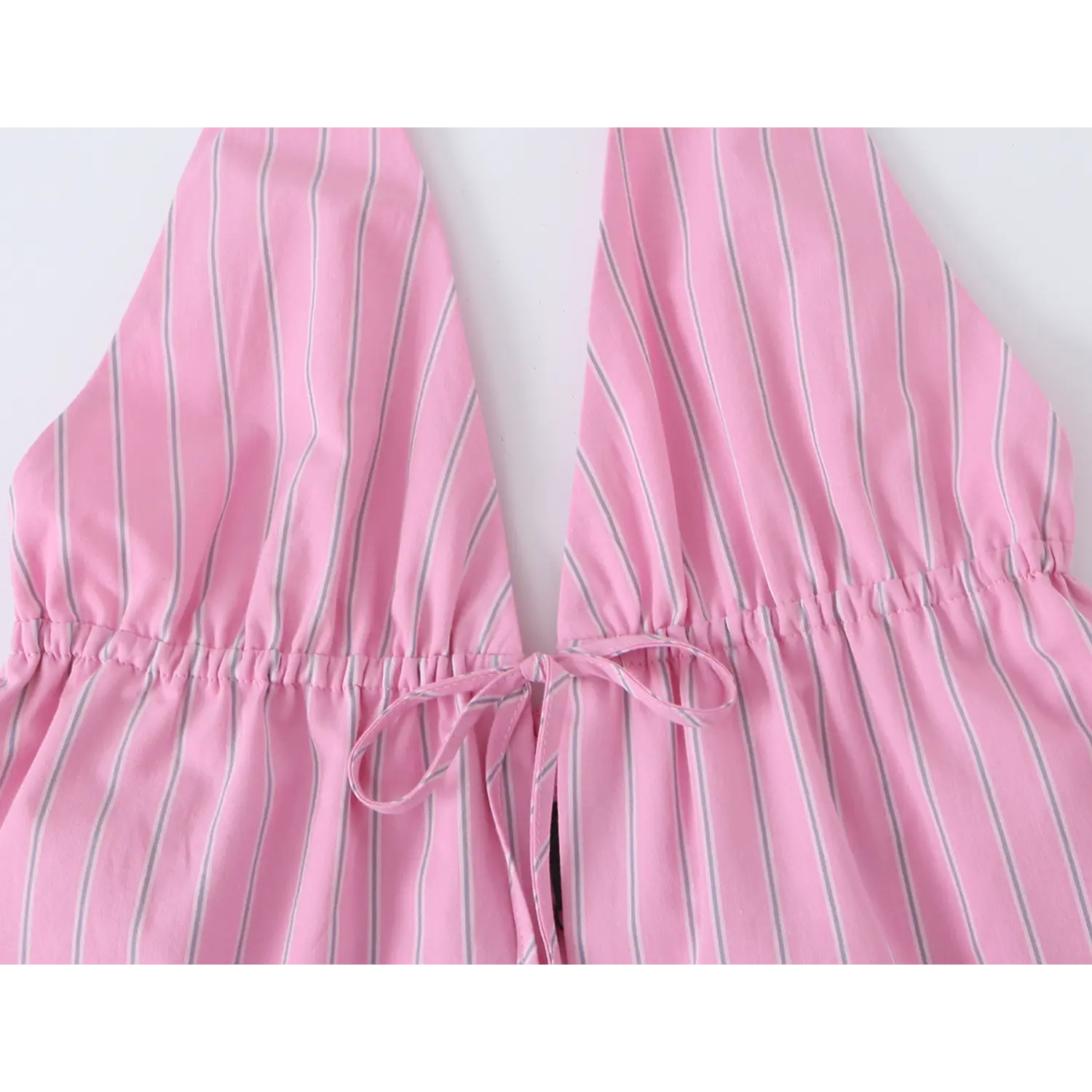 Close-up of front center self fabric tie, elastic shirred waistband shaping on pink striped camisole