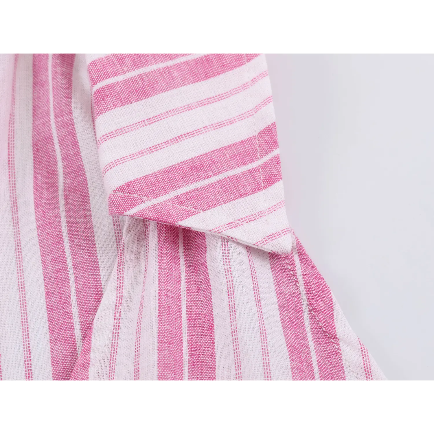 Macro close-up of folded lapel collar, consistent vertical stripe pattern and neat edge stitching