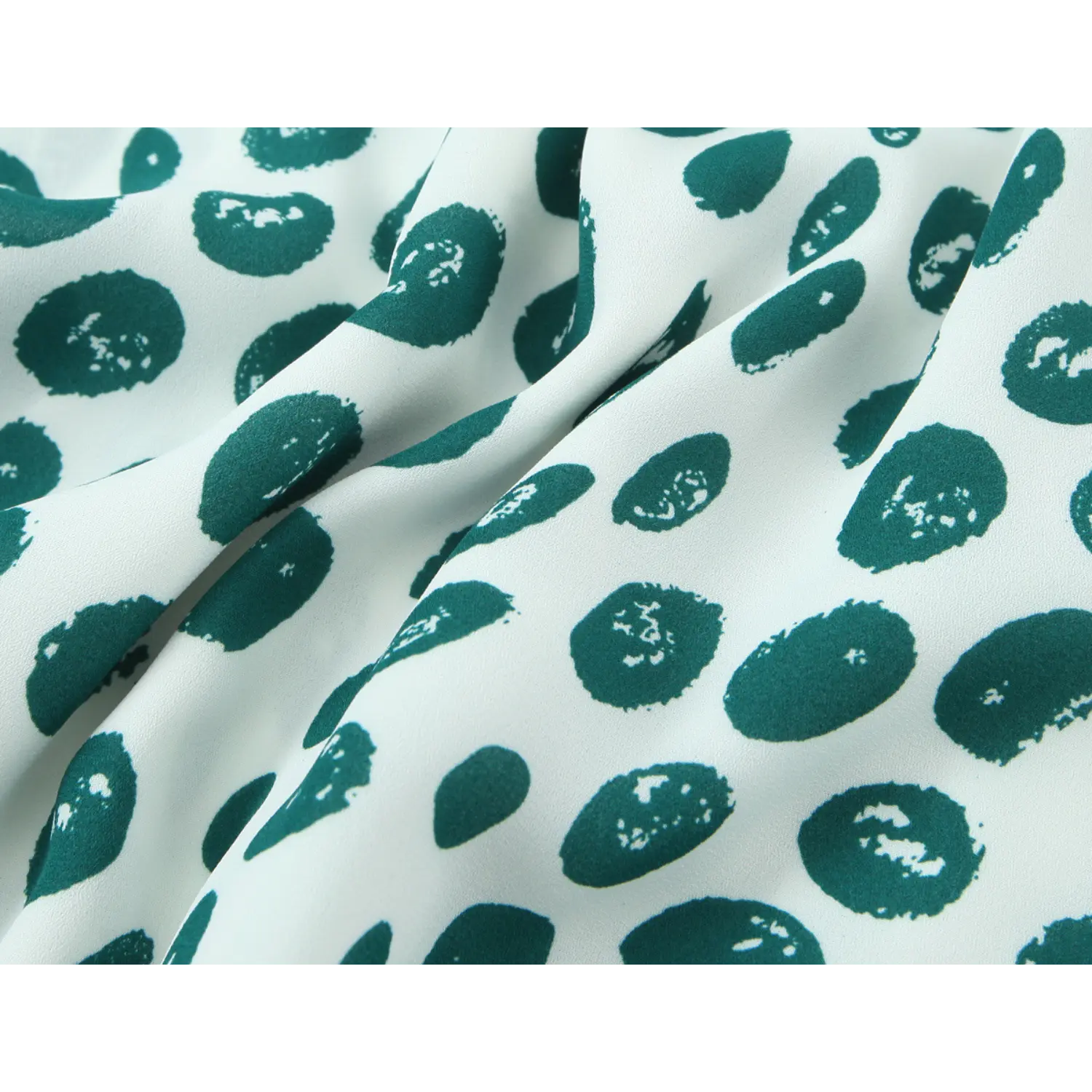 Macro texture shot soft lightweight woven fabric, off-white base dark green uneven brushstroke abstract dot print, matte smooth surface natural drape folds