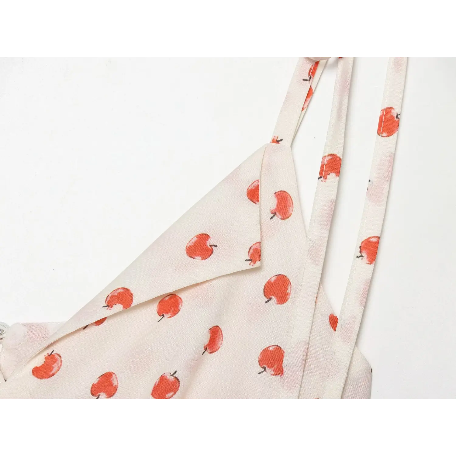 Hand drawn red apple print chiffon fabric flat close-up, thin drapable chiffon watercolor apple all over print breathable loungewear cloth shot